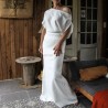 Front view of wedding dress with long train and off-the-shoulder design
