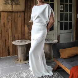 Side profile of sheath wedding gown showing train and form-fitting shape