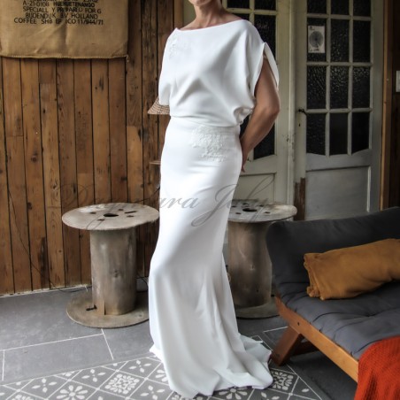 Side profile of sheath wedding gown showing train and form-fitting shape