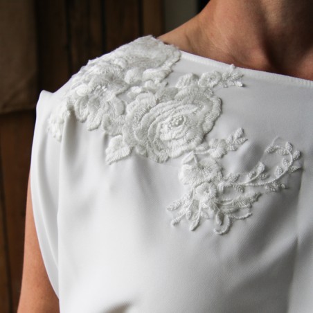 Detail of lace applique on sheath wedding dress bodice