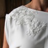 Detail of lace applique on sheath wedding dress bodice