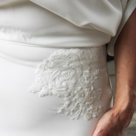 Detail of lace applique on sheath wedding dress bodice