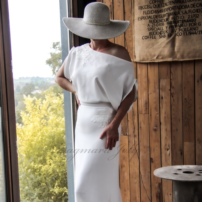 Off-the-shoulder sheath wedding dress with floor-length train, front view Off-the-shoulder sheath wedding dress with floor-length train, front view
