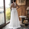 Back view of a handmade wedding gown with open halter back, lace detailing, and floral cotton fabric.