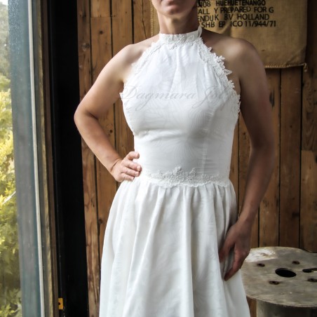 Fine stitching and floral texture on high-quality cotton fabric of a handmade wedding dress.
