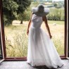 Model showcasing a romantic halter neck bridal gown, custom-fitted and crafted in France.