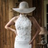 Bride wearing a modest halter neck sheath wedding dress with train, made of delicate cotton lace.