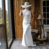 Bride standing in a modest halter neck lace wedding gown, capturing the dress’s movement and delicate details.