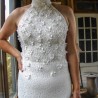Fine cotton lace texture and delicate embroidery on a modest sheath wedding dress.