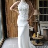 Bride standing gracefully in a sheath wedding dress with train, highlighting the dress’s clean lines and minimalist design.