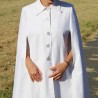 Flowing bridal cape caught in movement, highlighting its airy swing silhouette and oversized fit