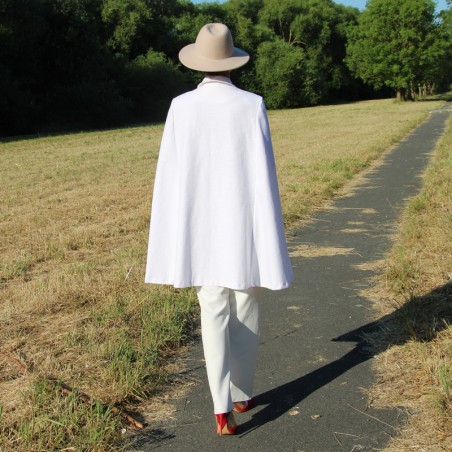 Back view of an oversized A-line bridal cape with flowing fabric and a clean, minimalist design