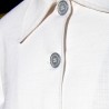 Close-up of silver button detailing on the front of a white cotton bridal cape with a tailored neckline.
