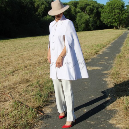 Modern bridal cape styled over a sleek pants, showcasing a contemporary alternative to a veil