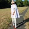 Modern bridal cape styled over a sleek pants, showcasing a contemporary alternative to a veil
