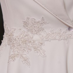 Gros plan sur les finitions brodées à la main de la robe de mariée