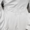 Gros plan sur les finitions brodées à la main de la robe de mariée