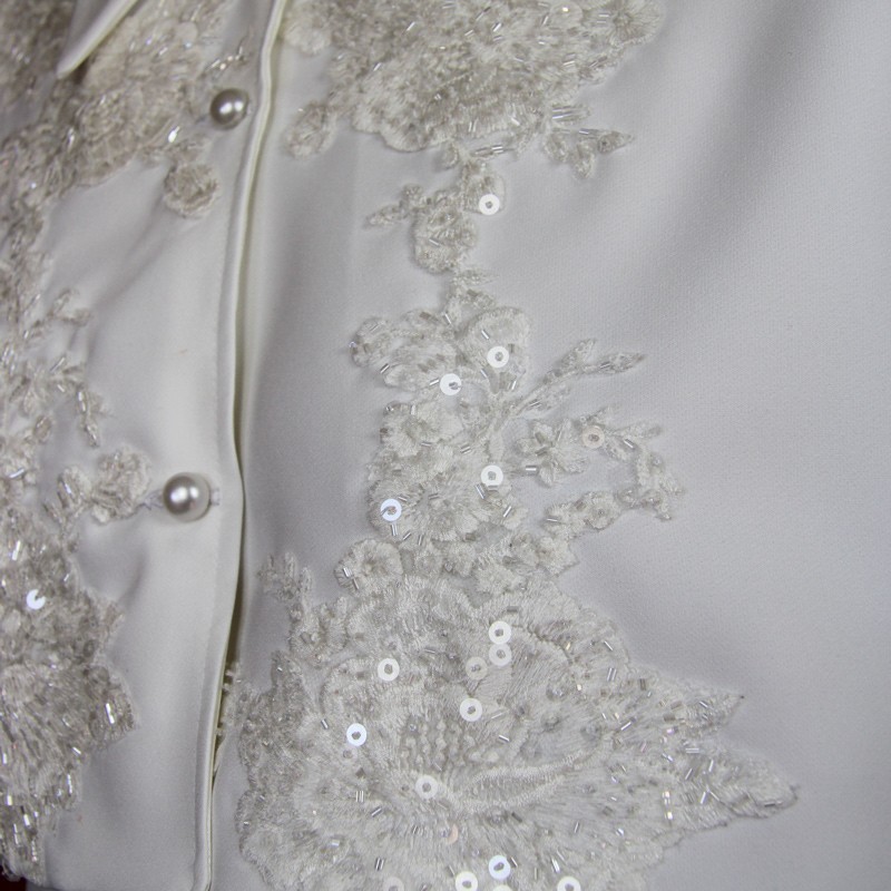 Details of Handmade wedding dress cape featuring lace, transparent sequins, and luxurious crystal decorations.