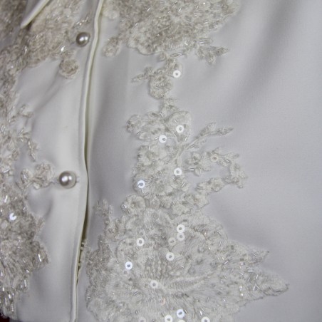 Details of Handmade wedding dress cape featuring lace, transparent sequins, and luxurious crystal decorations.