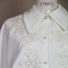Zoom on details of exquise hand embellishments and tailored collar