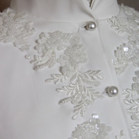 Close-up of delicate hand-embroidered beadwork on short crepe bridal cape.
