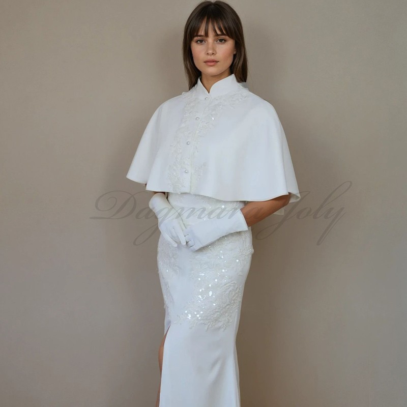 Élégante cape de mariage courte avec broderie et perles raffinées.