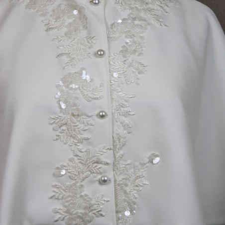 Zoomed-in view of intricate bead and embroidery detailing on wedding cape.