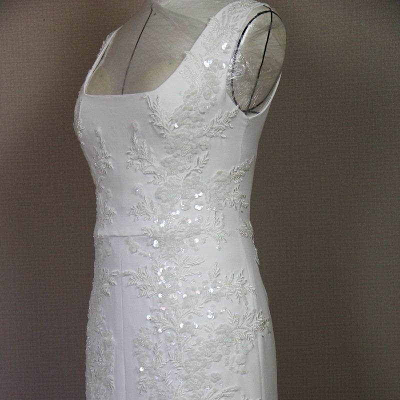 Close-up of square neckline on minimalist crepe bridal gown