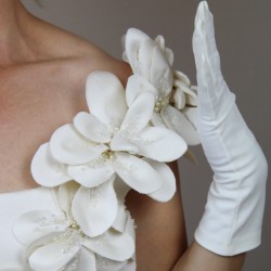 Close-up of luxurious couture fabric texture and hand embellishments on wedding dress