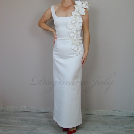 Model wearing handmade floor-length tube wedding dress with square neckline and minimalist silhouette