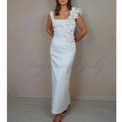 Bride wearing handmade French floor-length tube wedding dress with square neckline and minimalist silhouette