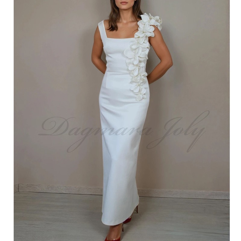 Bride wearing handmade French floor-length tube wedding dress with square neckline and minimalist silhouette