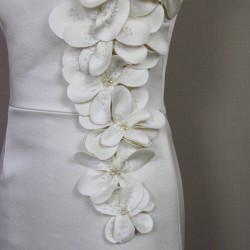 Detailed close-up of artisan-made appliqués with pearls and crystals on fabric