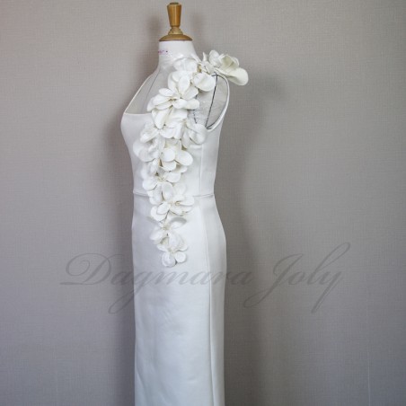 Detailed view of handcrafted fabric flowers and pearls on minimalist French bridal gown