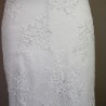 Fine lace texture and delicate embroidery on a modest sheath wedding dress.