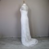 Back view of a halter neck wedding dress with elegant train and subtle lace detailing.