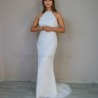 Bride standing gracefully in a sheath wedding dress with train, highlighting the dress’s clean lines and minimalist design.