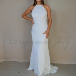 Front profile of a bride in a floor-length sheath lace dress featuring transparent tube decorations.