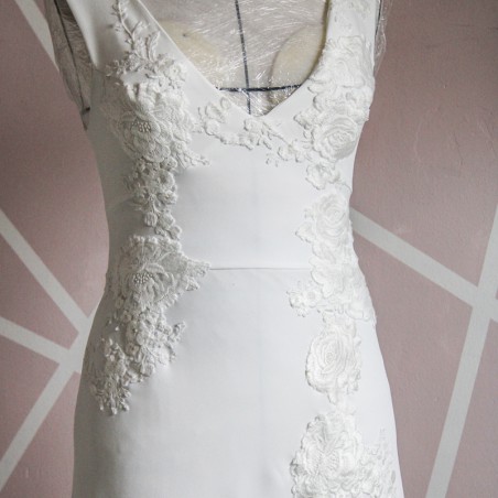 Close-up of hand embellishments on minimalist crepe bridal gown