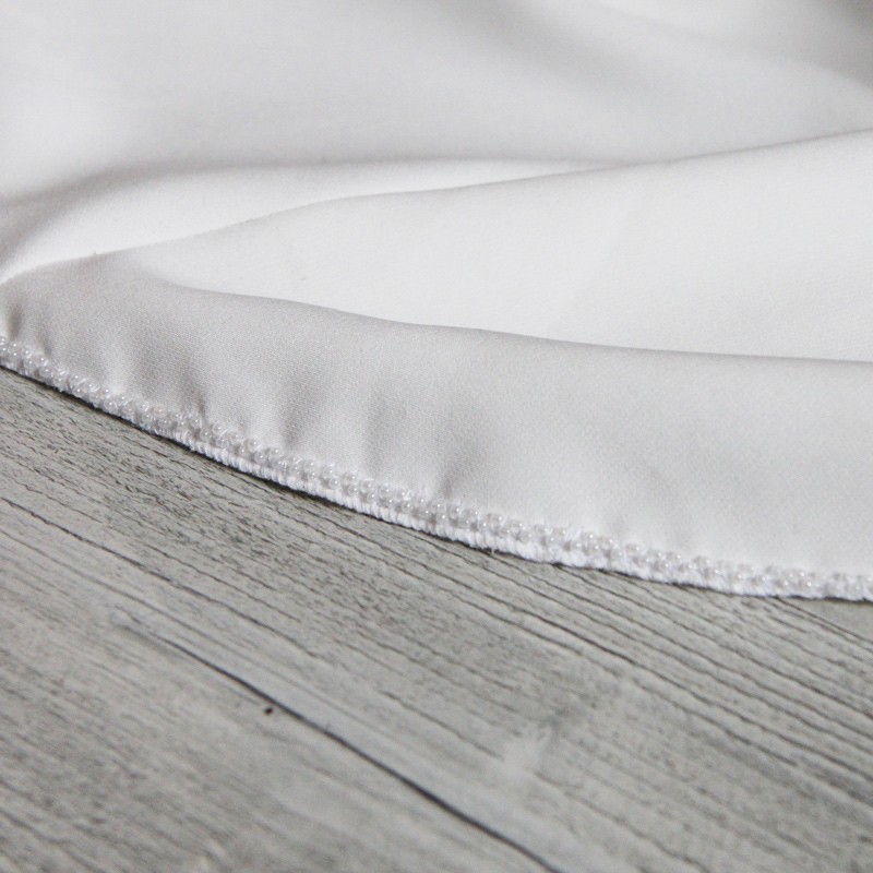 Close-up of hand embellishments on ourlet of minimalist floor length crepe bridal gown