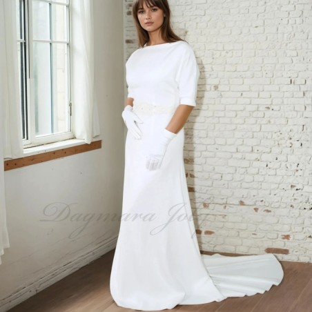 Front view of a floor-length wedding gown with dolman sleeves and cathedral train extending gracefully behind