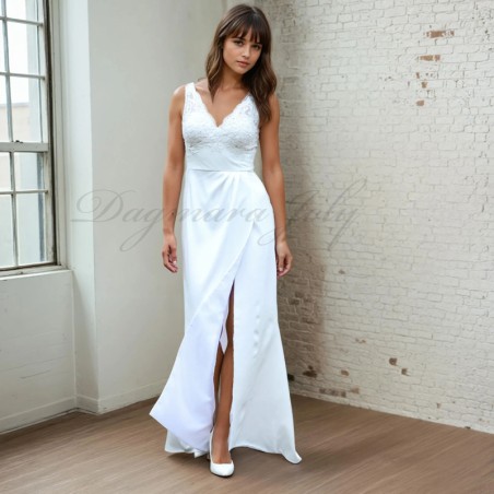 Model wearing high slit sleeveless wedding dress with train and V neckline,  front view