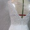 Detailed view of wedding dress train with lace and crystal appliqué