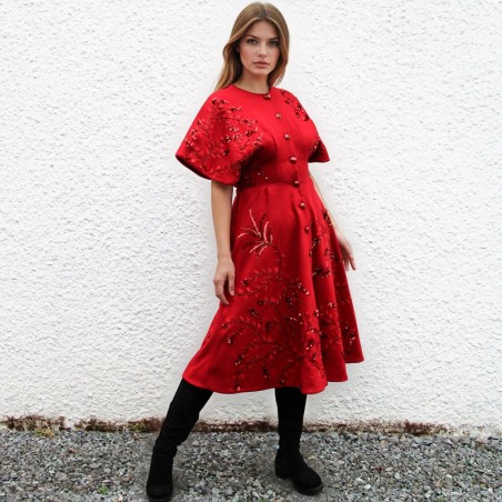 Women’s red wool coat with handmade embroidery, elegant below-knee design.