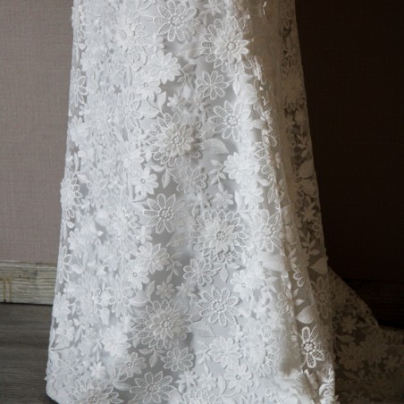 Fine cotton lace texture on a modest sheath wedding dress.