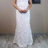 Fine cotton lace texture on a modest sheath wedding dress.