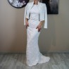 Bride standing gracefully in a sheath wedding dress with train, highlighting the dress’s clean lines and minimalist design.