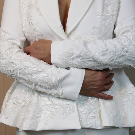 Minimalist bride wearing a modern white wedding pantsuit