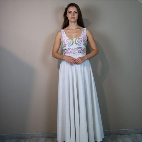 Bride wearing a long linen wedding dress with embroidered floral details