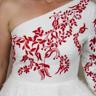 Zoom on the front and hand embroidery on midi wedding dress